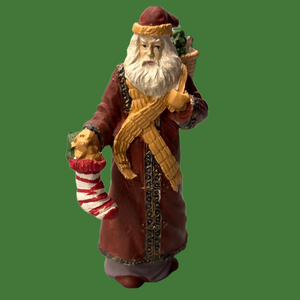 Santa collectible figure in plaster. Santa carries a stocking & basket of treats